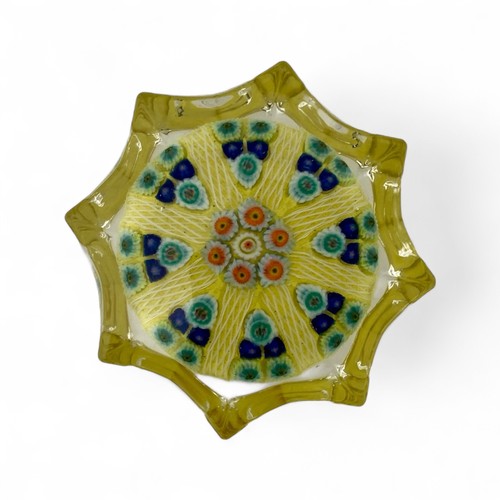 67 - Two large Strathearn eight spoke radial star moulded millefiori paperweights, with blue and yellow g... 