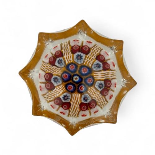 68 - Two large Strathearn seven spoke radial star moulded millefiori paperweights, with blue and orange g... 