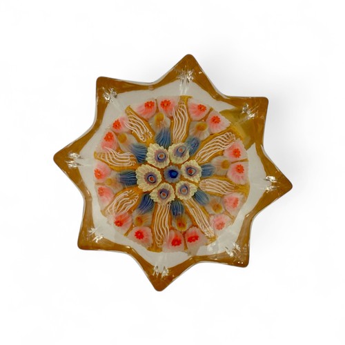 78 - Five medium Strathearn eight spoke radial star moulded millefiori paperweights, with black, blue and... 