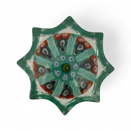 78 - Five medium Strathearn eight spoke radial star moulded millefiori paperweights, with black, blue and... 