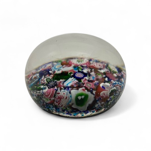 99 - A mid-19th century French Clichy 'scrambled' ground paperweight, with multiple millefiori canes incl... 