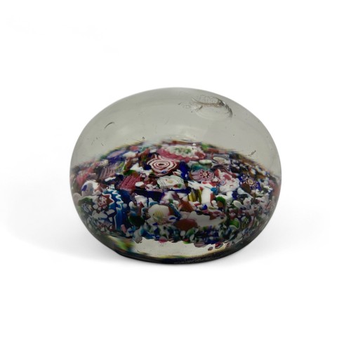 99 - A mid-19th century French Clichy 'scrambled' ground paperweight, with multiple millefiori canes incl... 