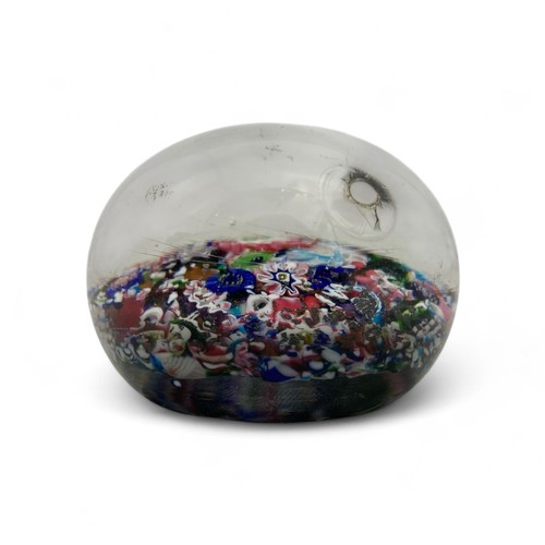 99 - A mid-19th century French Clichy 'scrambled' ground paperweight, with multiple millefiori canes incl... 