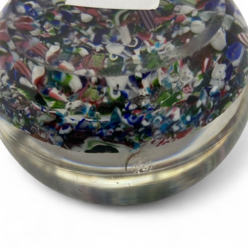 99 - A mid-19th century French Clichy 'scrambled' ground paperweight, with multiple millefiori canes incl... 