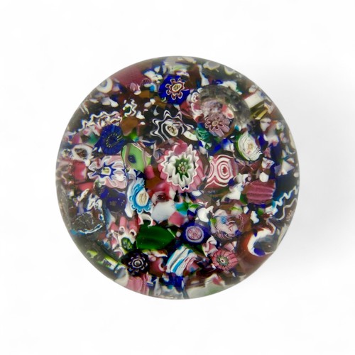 99 - A mid-19th century French Clichy 'scrambled' ground paperweight, with multiple millefiori canes incl... 