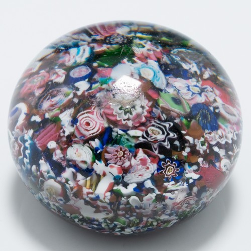 99 - A mid-19th century French Clichy 'scrambled' ground paperweight, with multiple millefiori canes incl... 