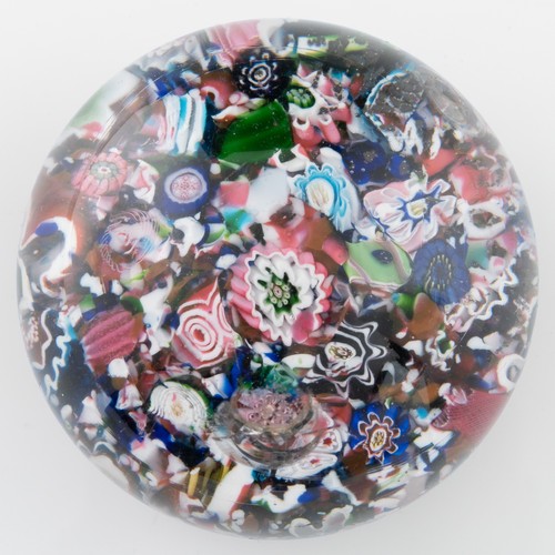 99 - A mid-19th century French Clichy 'scrambled' ground paperweight, with multiple millefiori canes incl... 