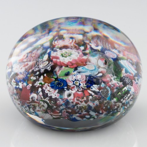 99 - A mid-19th century French Clichy 'scrambled' ground paperweight, with multiple millefiori canes incl... 