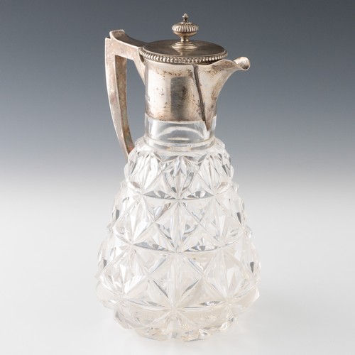 116 - An English Edwardian silver mounted cut glass claret jug, the glass jug with deeply cut mitre cuts a... 