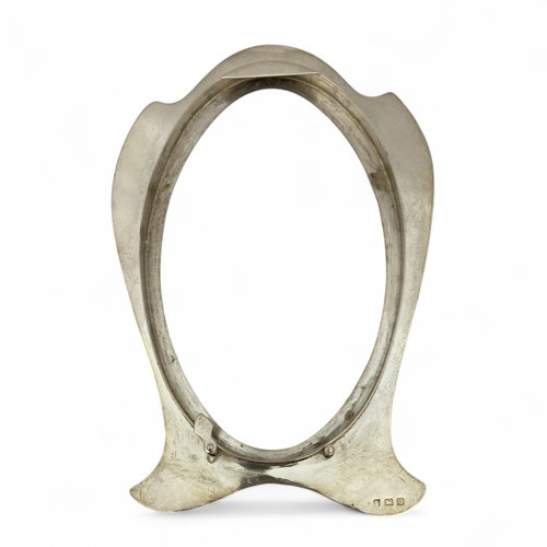 127 - An Art Nouveau silver desk picture or photo frame, the curving form with rubbed Birmingham hallmarks... 