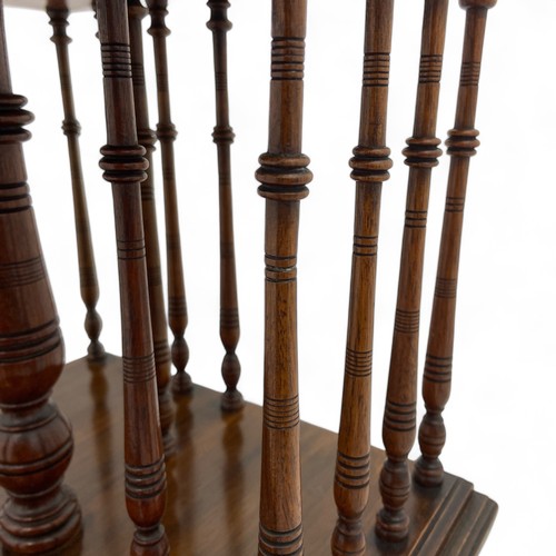 222 - A late Victorian or Edwardian mahogany table top revolving bookstand, with turned spindle supports, ... 