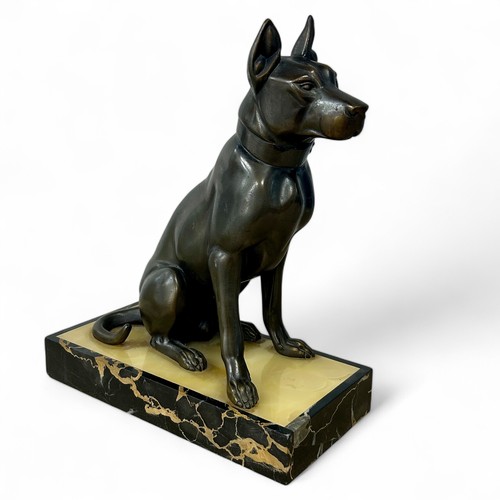 176 - A 1920s-30s French Art Deco patinated spelter sculpture of a dog, resembling bronze, on a yellowy-wh... 