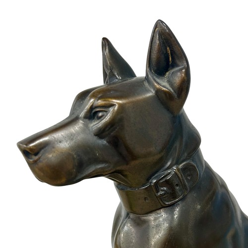 176 - A 1920s-30s French Art Deco patinated spelter sculpture of a dog, resembling bronze, on a yellowy-wh... 