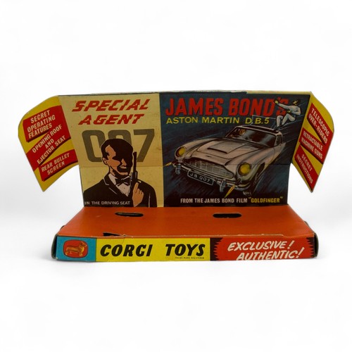 242 - A Corgi Toys No.261 'James Bond' Aston Martin DB5 model car, finished in gold, with wire wheels, red... 