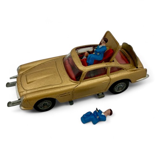 242 - A Corgi Toys No.261 'James Bond' Aston Martin DB5 model car, finished in gold, with wire wheels, red... 