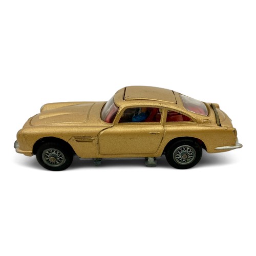 242 - A Corgi Toys No.261 'James Bond' Aston Martin DB5 model car, finished in gold, with wire wheels, red... 