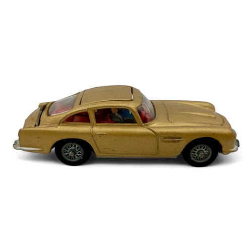 242 - A Corgi Toys No.261 'James Bond' Aston Martin DB5 model car, finished in gold, with wire wheels, red... 