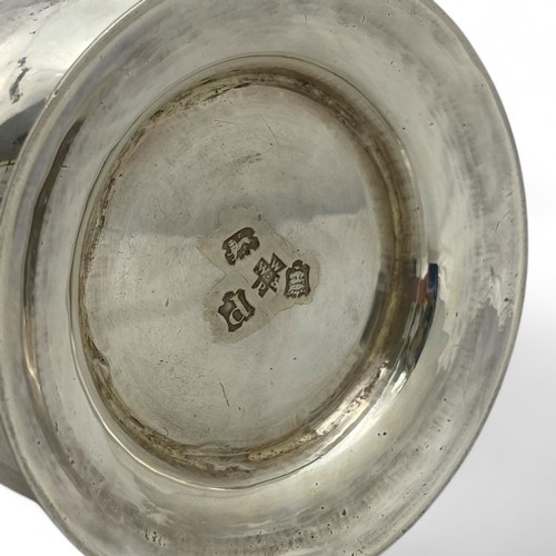 121 - A George II silver tankard, of plain finish with a scroll handle, the body with an erased inscriptio... 