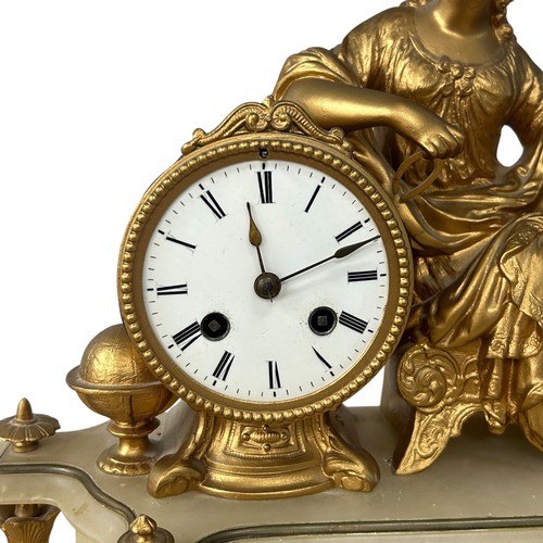 169 - A late 19thC Neoclassical style alabaster and gilt metal clock, with a reclining lady holding calipe... 