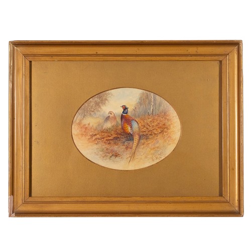 188 - James Stinton (1870-1961), an oval watercolour of a pheasant and hen amidst brown ferns in a clearin... 