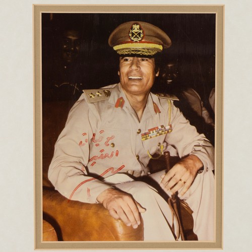 232 - A signed colour photograph of Colonel Muammar Al-Gaddafi (1942-2011), the ex-Libyan leader from 1969... 