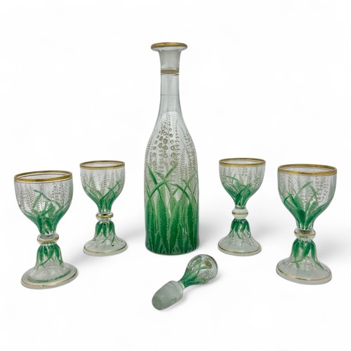 105 - An early 20thC French enamelled glass stoppered decanter and four wine goblets, attributed to Delvau... 