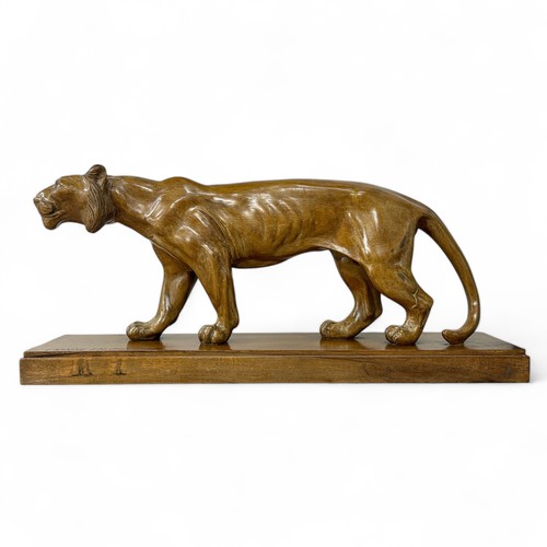 177 - A 1920s-30s French Art Deco carved wood sculpture of a prowling lioness embarking on a hunt, by an u... 