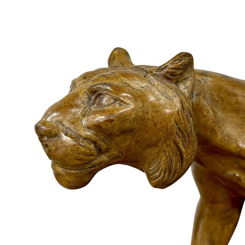 177 - A 1920s-30s French Art Deco carved wood sculpture of a prowling lioness embarking on a hunt, by an u... 