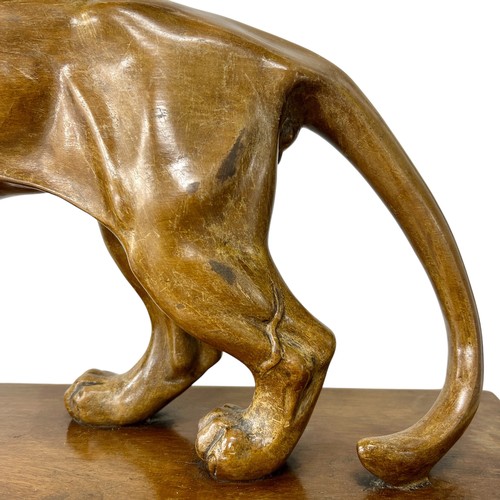 177 - A 1920s-30s French Art Deco carved wood sculpture of a prowling lioness embarking on a hunt, by an u... 