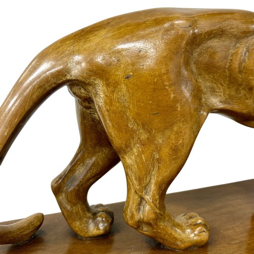 177 - A 1920s-30s French Art Deco carved wood sculpture of a prowling lioness embarking on a hunt, by an u... 