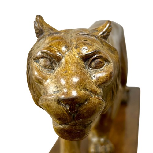 177 - A 1920s-30s French Art Deco carved wood sculpture of a prowling lioness embarking on a hunt, by an u... 