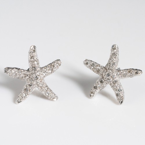 157 - A pair of 18ct white gold and chip diamond earrings, in the shape of starfish, stamped '18K', with 1... 