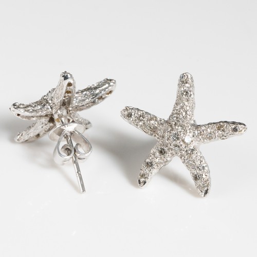 157 - A pair of 18ct white gold and chip diamond earrings, in the shape of starfish, stamped '18K', with 1... 