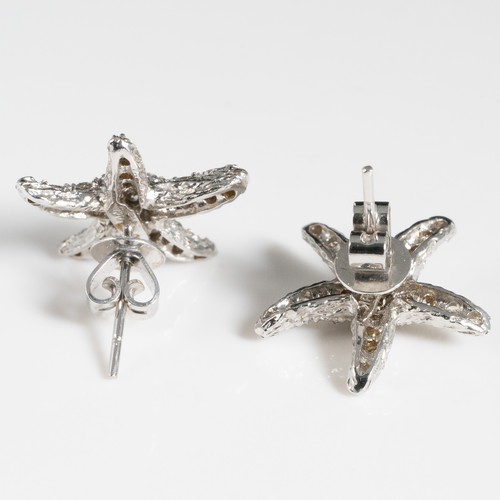 157 - A pair of 18ct white gold and chip diamond earrings, in the shape of starfish, stamped '18K', with 1... 