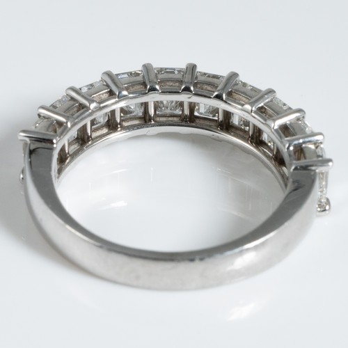 150 - A George Pragnell Ltd platinum and diamond half hoop or half eternity ring, claw set with 10 emerald... 