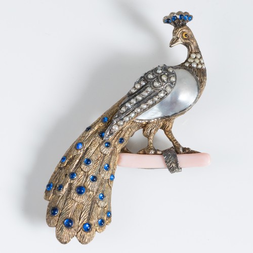 153 - A late 19th century silver gilt peacock shaped brooch, probably central European, the peacock standi... 