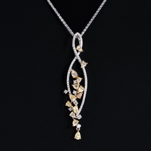 162 - An 18ct white gold curving pendant, claw set with 13 pear-shaped cut fancy yellow diamonds totalling... 