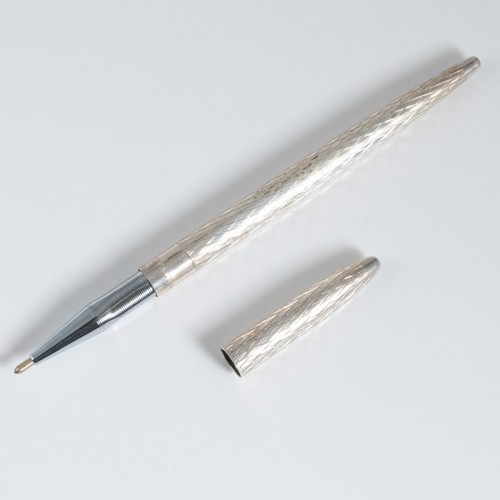 164 - A late 20thC Tiffany white metal lidded ballpen, with engraved chevron pattern, the band engraved 'T... 