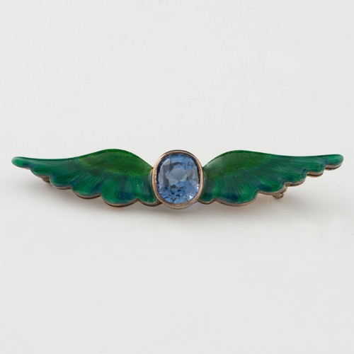 152 - A late 19thC or early 20thC gold, enamel and sapphire wing-shaped brooch, the gently double-curved w... 