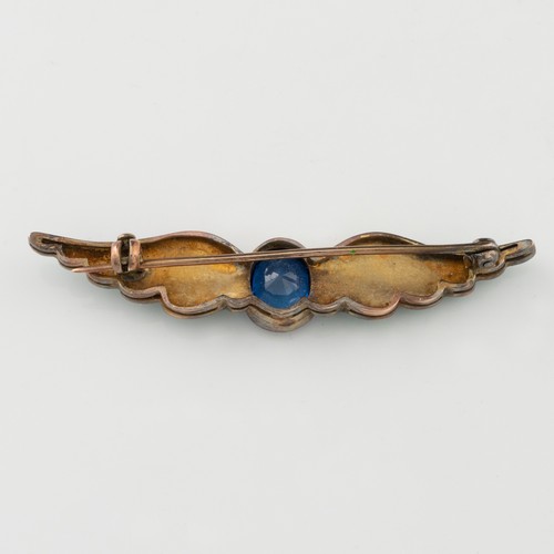 152 - A late 19thC or early 20thC gold, enamel and sapphire wing-shaped brooch, the gently double-curved w... 