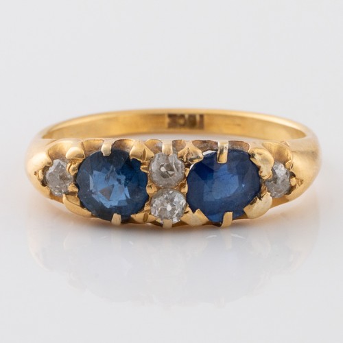 145 - A late 19th century or early 20th century 18ct gold sapphire and diamond half eternity dress ring, m... 