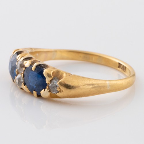 145 - A late 19th century or early 20th century 18ct gold sapphire and diamond half eternity dress ring, m... 