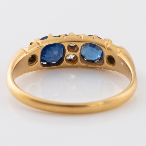 145 - A late 19th century or early 20th century 18ct gold sapphire and diamond half eternity dress ring, m... 