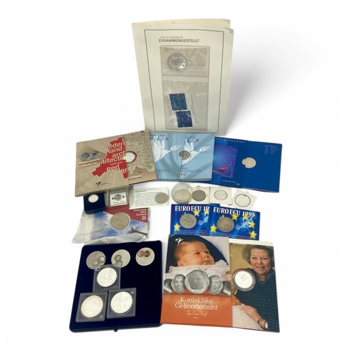 237 - A collection of sixteen sets and individual white metal Dutch and European commemorative coins, some... 