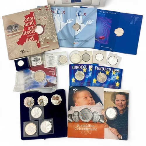 237 - A collection of sixteen sets and individual white metal Dutch and European commemorative coins, some... 