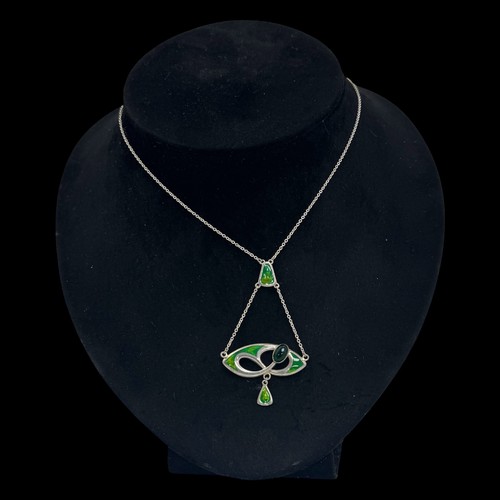 143 - A Charles Horner silver and enamel pendant, decorated with an openwork design set with  a dark green... 