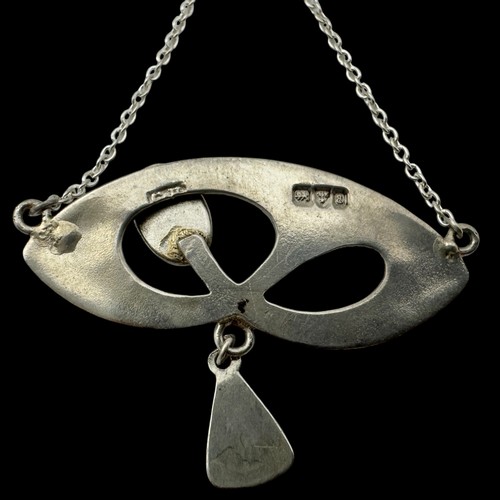 143 - A Charles Horner silver and enamel pendant, decorated with an openwork design set with  a dark green... 