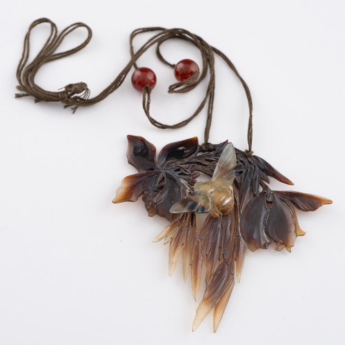 138 - An early 20thC French Art Nouveau carved horn pendant, probably by Elizabeth Bonté, modelled as a wi... 