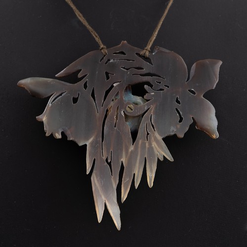 138 - An early 20thC French Art Nouveau carved horn pendant, probably by Elizabeth Bonté, modelled as a wi... 