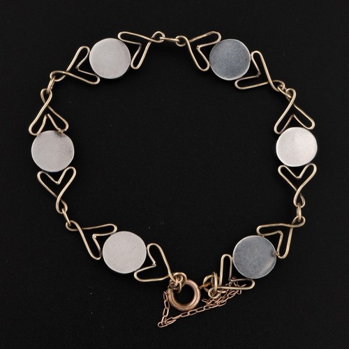 128 - An Arts and Crafts style bracelet with blister pearls, decorated with heart-shaped wirework, roundel... 
